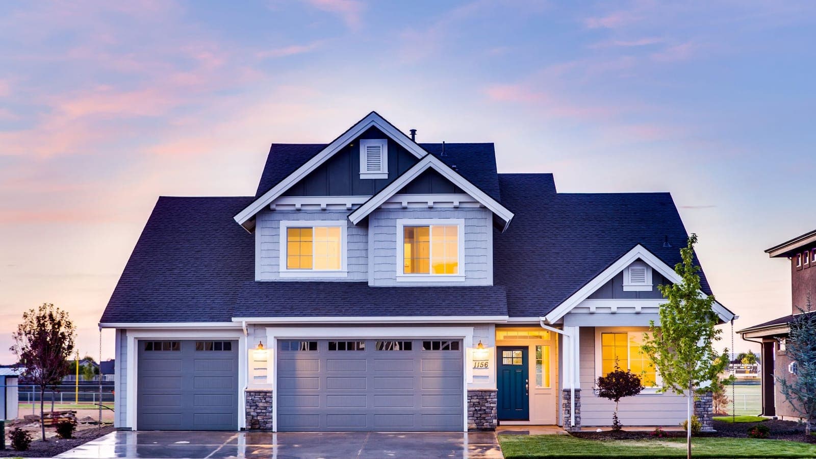 A bright, welcoming single-family home with a tidy lawn and clear blue sky