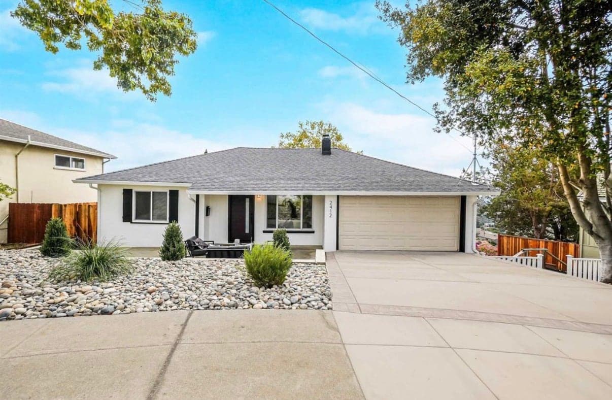 Renovated ranch home with river-rock landscaping