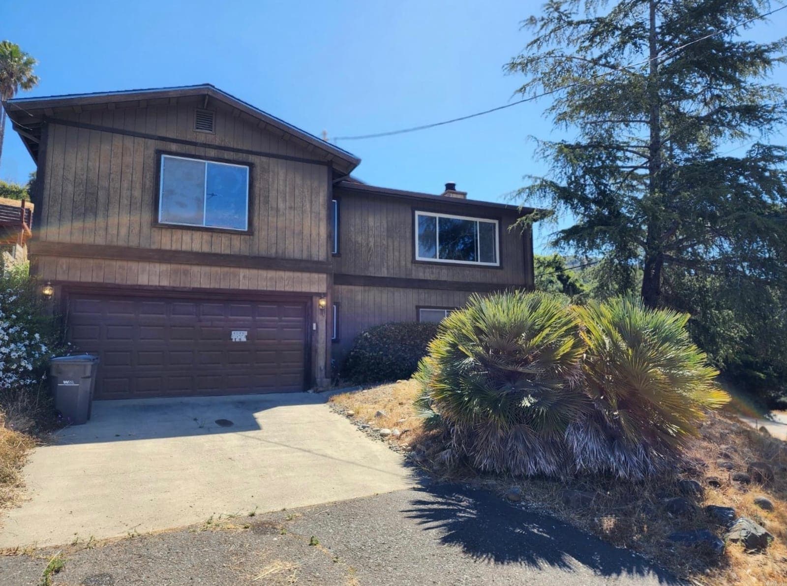 Split-level home before and after a modern exterior renovation — before